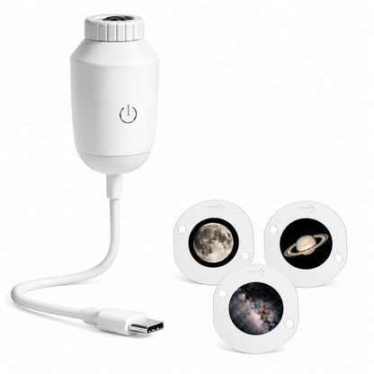 A white electronic device with a USB-C cable and three circular magnetic accessory pieces featuring space-themed designs of the moon, Saturn, and a galaxy, shown on a solid white background.